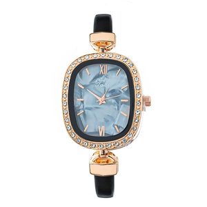 Women's rose gold oval watch with marble dial and rhinestone bezel on black strap