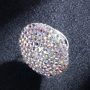 Macro view of silver geometric ring featuring sparkling multi-colored rhinestones on black