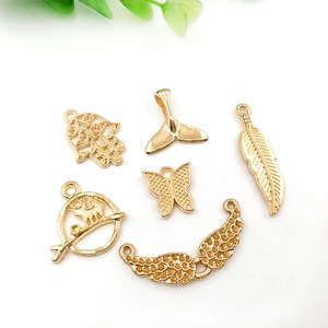 Mix of gold alloy charms for DIY jewelry making including feather and butterfly shapes