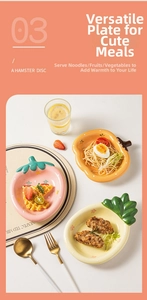 Detail of fruit-shaped ceramic plates featuring strawberry, pumpkin, and pineapple designs