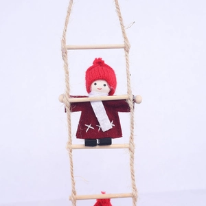 Close-up of wool felt Christmas elf climbing a wooden rope ladder decoration