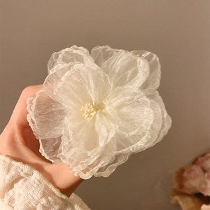 Delicate white mesh flower hair clip with layered petals and soft yellow center