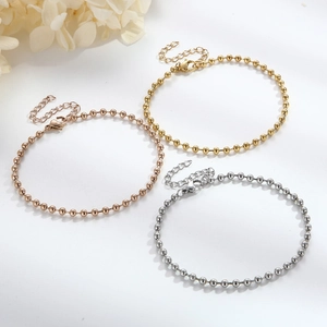 Three beaded steel chain bracelets in gold, rose gold and silver with lobster clasps