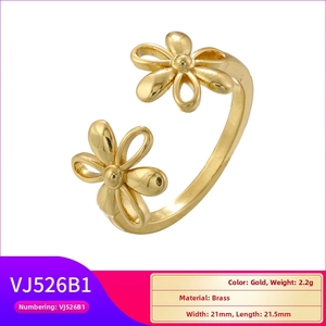 Macro shot of gold brass double flower open ring showing hollow petal details