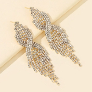 Detailed view of gold tassel earrings featuring sparkling white rhinestones and crystals