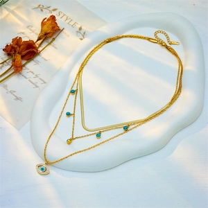 Multilayer gold chain necklace with turquoise beads and evil eye diamond pendant