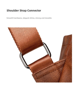 Detail of durable brown woven shoulder strap with polished gunmetal hardware and stitching