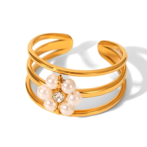 Detail of three-layer gold steel ring featuring a pearl flower and crystal center