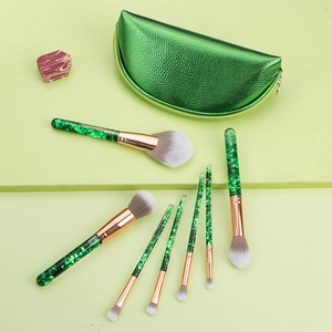 7-piece green glitter makeup brush set with gold ferrules and matching cosmetic pouch