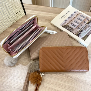 Long V-quilted women's zipper wallet with pompom charm and multi-card slot interior