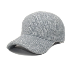 Close-up of thick knitted baseball cap with subtle glitter threads and warm texture