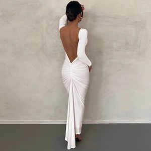 Detail view of the open back design and gathered pleats on the white maxi dress