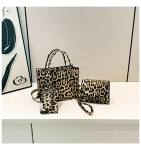 Detailed view of the three-piece leopard print bag set with golden hardware accents