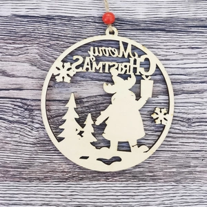 Close-up of wooden Merry Christmas ornament with Santa Claus and snowflake carving