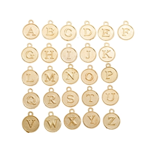 Flat lay of 26 gold alloy alphabet pendants from A to Z for DIY jewelry making