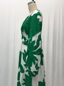 Detail of green and white leaf print lantern sleeves on a long V-neck woven maxi dress