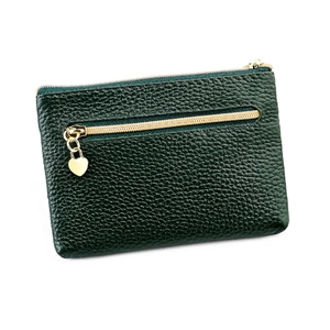 Macro detail of dark green pebbled leather coin purse with golden heart pendant and zippers