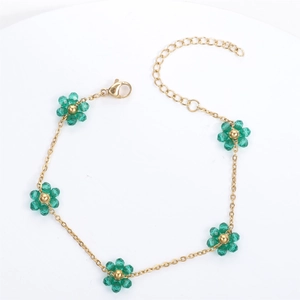 Golden stainless steel chain bracelet featuring five green crystal flowers and lobster clasp