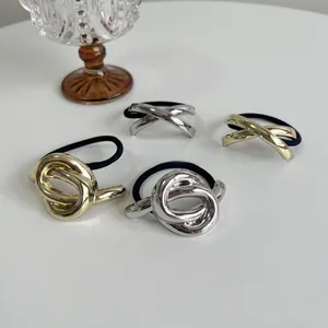 Set of 4 gold and silver metal knot elastic hair ties with minimalist geometric designs