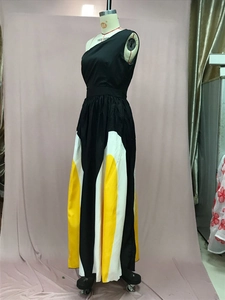 Detail of color-block patchwork long dress with one-shoulder design and pleated texture
