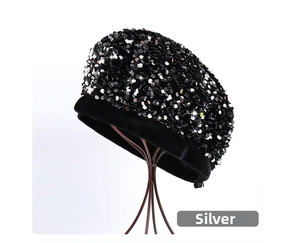Detail of silver sequins on black velvet beret with metallic shine on a stand