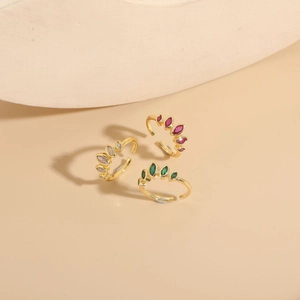 Detail of 14K gold plated crown rings with marquise white, red, and green cubic zirconia