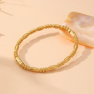 Detail of gold bamboo-style link bracelet with circular beads and secure clasp closure