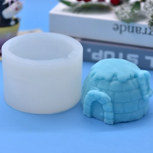 3D igloo shaped silicone mold with blue finished cake showing detailed ice brick texture
