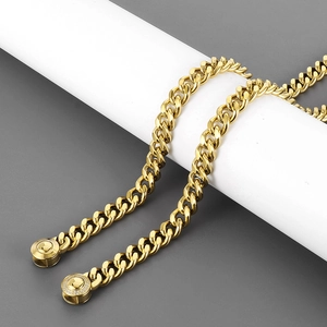 Detail of gold Cuban chain with CNC rhinestones around the circular clasp on white stand