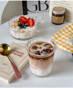 Detail showing a bow pattern glass bowl with yogurt and a matching iced coffee cup