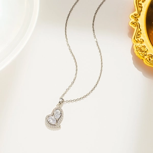 Silver heart pendant necklace with shimmering zircon stones on an elegant O-chain link