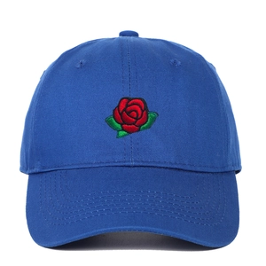 Close-up of red rose embroidery detail on a navy blue cotton twill baseball cap