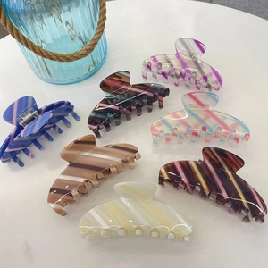 Set of 7 colorful striped acetate hair claws in various vibrant candy colors