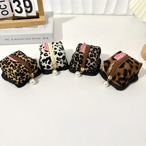 Detail of vintage leopard print corduroy earphone pouches with elegant pearl zipper charms