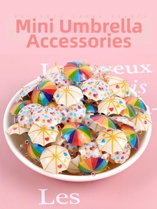 Close-up of colorful resin mini umbrella charms with metal hooks for DIY jewelry