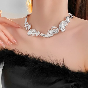 Close-up of irregular silver lava texture chunky chain necklace worn by model