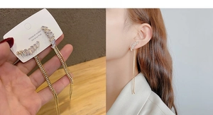 Detail of gold tassel earrings with zircon stones and 925 silver needles on display card