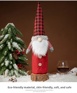 Close-up of Christmas gnome wine bottle cover with red plaid hat and white beard detail