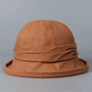 Detail view of high-quality rust brown linen bucket hat for women showing fabric texture