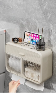 Macro detail of cream wall-mounted toilet paper holder with top shelf for phone