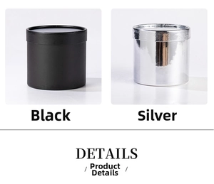 Detailed view of small round flower gift boxes in matte black and metallic silver finishes