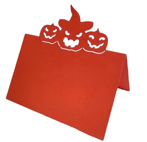 Halloween place cards featuring red pumpkin cutout design for festive table settings