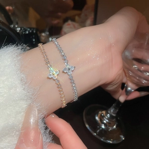 Close-up of elegant flower bracelets with cubic zirconia in silver and rose gold