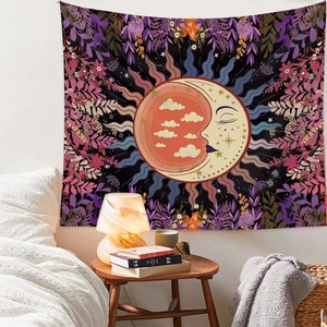Cozy bedroom setting showing a bohemian sun and moon tapestry hanging on a white wall