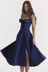 Detail view of navy blue strap dress featuring waist cinch and side slit design