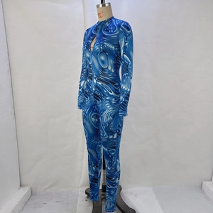 Detail view of long-sleeve jumpsuit with blue marble pattern and cutout neckline