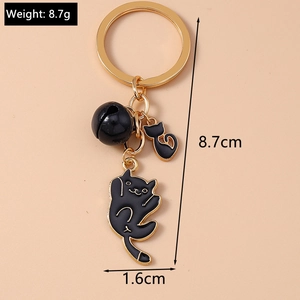 Detail shot of a black cat keychain showing 8.7cm length and weight specifications