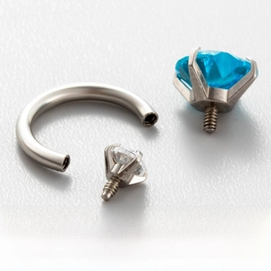 Macro detail of titanium steel horseshoe ring with double internal thread zircon stones