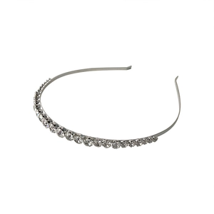 Elegant silver metal headband with sparkling round rhinestones on a white background