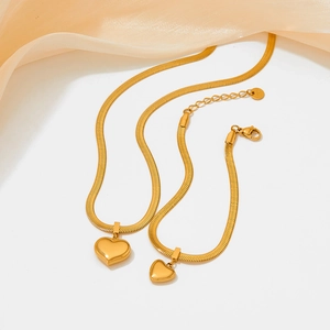 Golden stainless steel jewelry set featuring a snake chain necklace and heart pendant